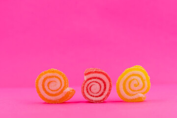 Three spiral jelly candy and pastel pink background