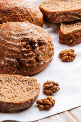 Closeup on rye walnut bread on the wooden decorated table