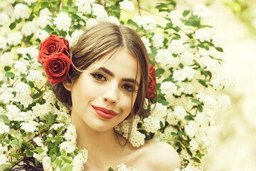 Young woman in spring blossom flower. Pretty girl with fashionable makeup and red lips. Hispanic style. Spring blossom on natural background.