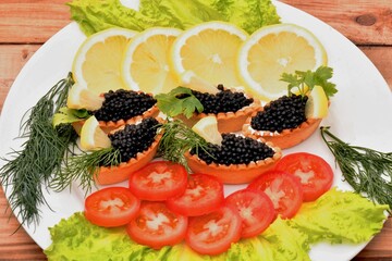 Tartlets with black caviar