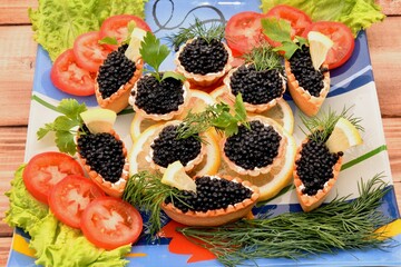 Tartlets with black caviar