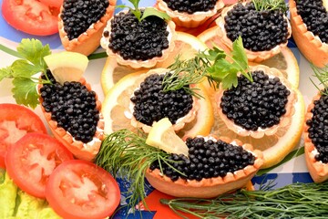 Tartlets with black caviar