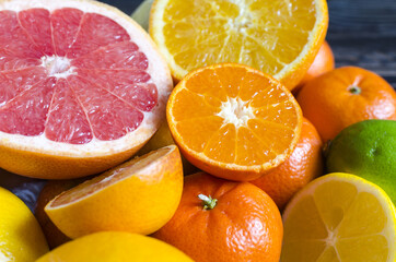 tangerines lemons oranges limes citrus fruits close up on a wooden background