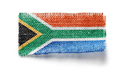 South Africa flag on a piece of cloth on a white background