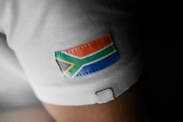Patch of the national flag of the South Africa on a white t-shirt