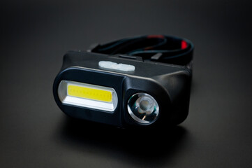 LED headlamp with two light sources for tourism, sports and work.