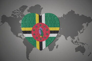 puzzle heart with the national flag of dominica on a world map background.
