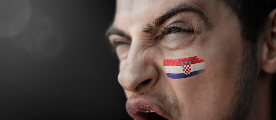 A screaming man with the image of the Croatia national flag on his face - obrazy, fototapety, plakaty