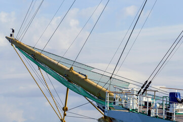 Masts and rigging of a sailing ship against sky