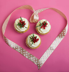Valentines cupcakes with vanilla icing on a pink background