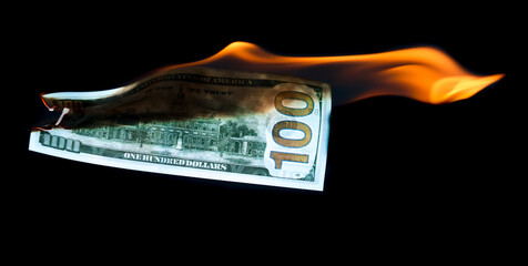 One Hundred Dollars are burning on a black