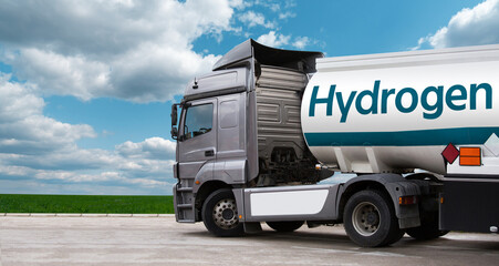 Truck with hydrogen fuel tank trailer on a background of green field and blue sky	
