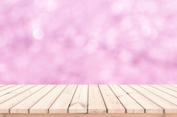 Wood table or wood floor with abstract pink bokeh background for product display