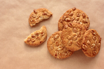 Peanut cookies on kraft paper. Close-up of homemade pastry on brown background with copy space