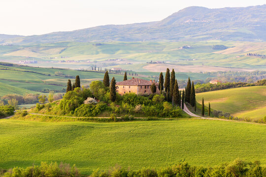 Farm house on a hill in rural Tuscany landscape