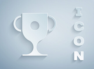 Paper cut Award cup icon isolated on grey background. Winner trophy symbol. Championship or competition trophy. Sports achievement sign. Paper art style. Vector Illustration.