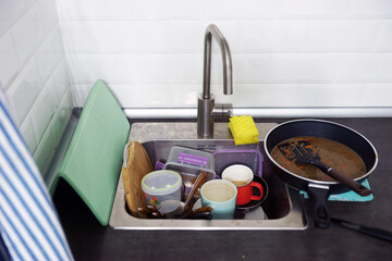 Kitchen sink full of dirty dishes