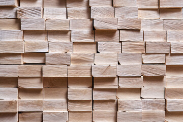 Large stack of new boards of natural solid birch for table legs production in contemporary carpentry warehouse close view