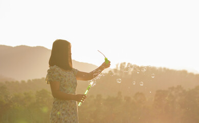 Girl playing bubbles having fun nature