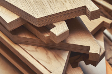 Naklejka na ściany i meble Stack of new details to assemble balanced steps for elegant stairs of plywood and solid beechwood in carpentry shop closeup