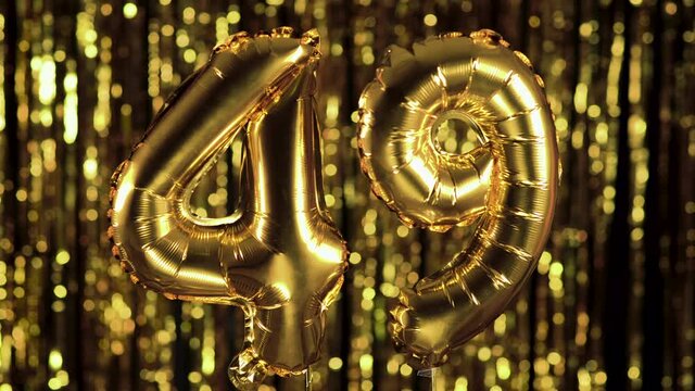 The golden number 49 forty nine one is made of an inflatable balloon on a yellow background. One of the complete set of numbers. Birthday, anniversary, date concept - Powered by Adobe
