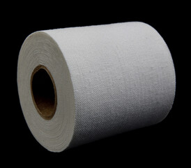 Medical sticking plaster roll isolated on black. First aid item