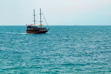 Fototapeta na wymiar Tourist yacht off the coast of Antalya, Turkey.