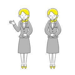 グレーのスーツを着て案内をする女性