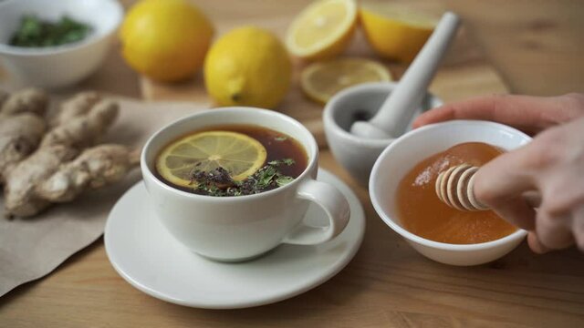 Put a teaspoon of honey in a Cup of hot tea with lemon.