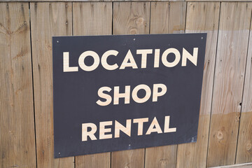 location shop rental text sign on wooden wall store background