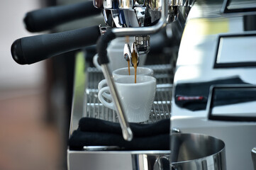 Espresso. Detail of coffee flowing from a professional espresso machine.