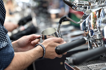 Fototapeta premium Detail of hand, glass and freshly roasted coffee.