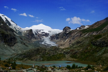 view to a high mountain with snow and a glacier with blue sky