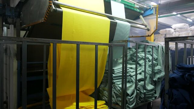 Fabrication and dyeing of fabric at the factory. Textile factory industry.