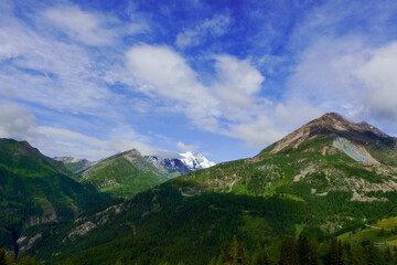 wonderful blue sky with soft clouds in green mountains