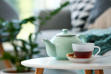 Teapot and cup on table in room