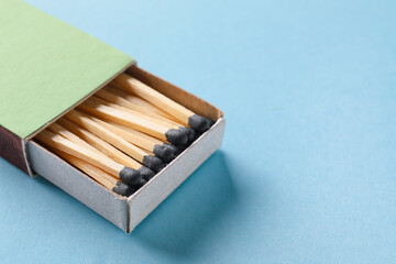 Box with matches on color background
