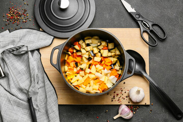 Vegetables in cooking pot on dark background