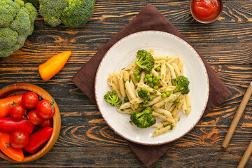Tasty pasta with vegetables on wooden background