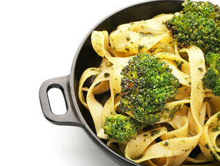 Frying pan with tasty pasta and broccoli on white background, closeup