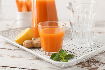 Glass of tasty carrot juice on food tray