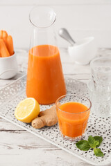 Glass of tasty carrot juice on food tray