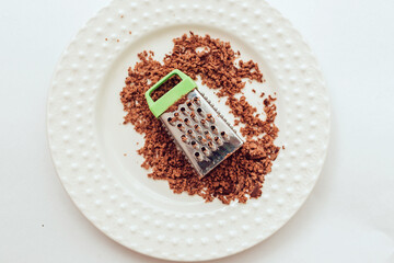 Grate Chocolate Bar Using Handheld Grater. Making Boston Banoffee Pie.