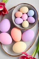 Composition with beautiful Easter eggs on light background