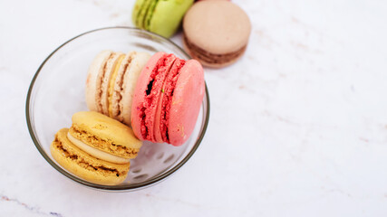 Delicious three multicolored macaroon on a white background