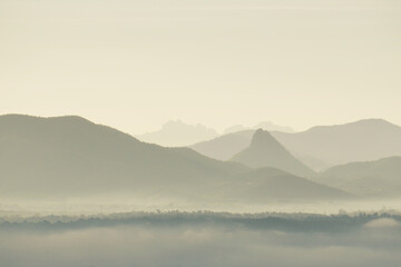 Fototapeta premium Landscape Mountains with mist fog in the morning - nature scenery from Phuthok Chaing Khan Loei Thailand ,Tourism and travel concept image, Fresh and relax type nature image background 