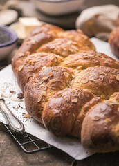Tsoureki braid, greek easter sweet bread, on wood