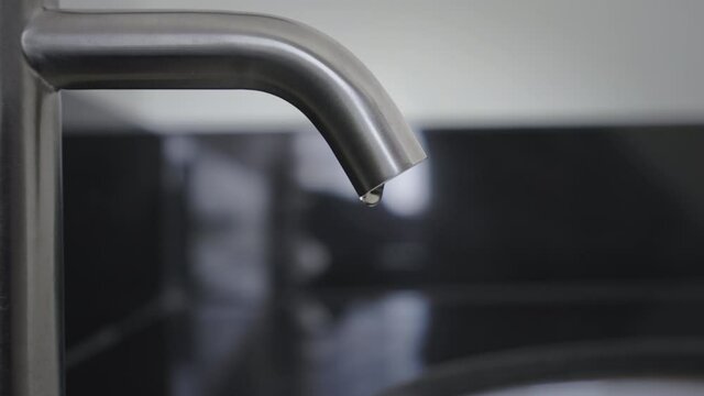 Close up wash basin water drop in bathroom, Stainless steel water tap or water vale have water drop,Slow motion water dope chrome faucet in the toilet,Concept save water energy and protect environment