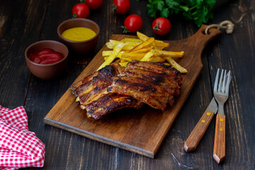 Barbecue ribs with French fries. American cuisine. Grill. Bbq.