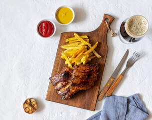 Barbecue ribs with French fries. American cuisine. Grill. Bbq.